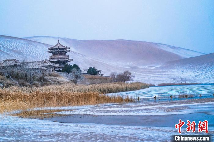 2021年11月28日，雪落鳴沙山月牙泉景區(qū)?！⊥醣筱y 攝